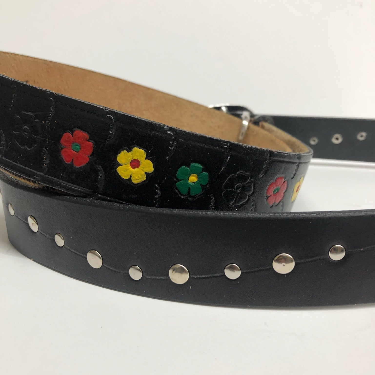 Black leather belt with floral tooling. Black leather belt with silver rivets