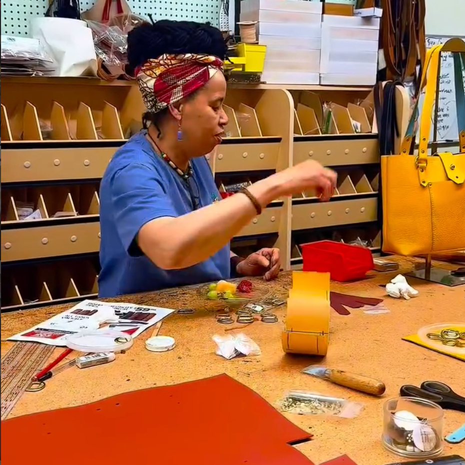 Person working at a craft table with various tools and materials

Details